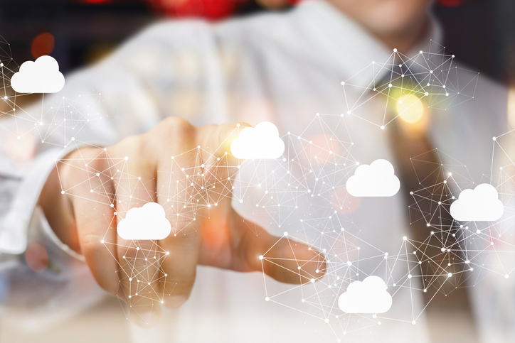 The businessman clicks on the cloud in network on blurred background.