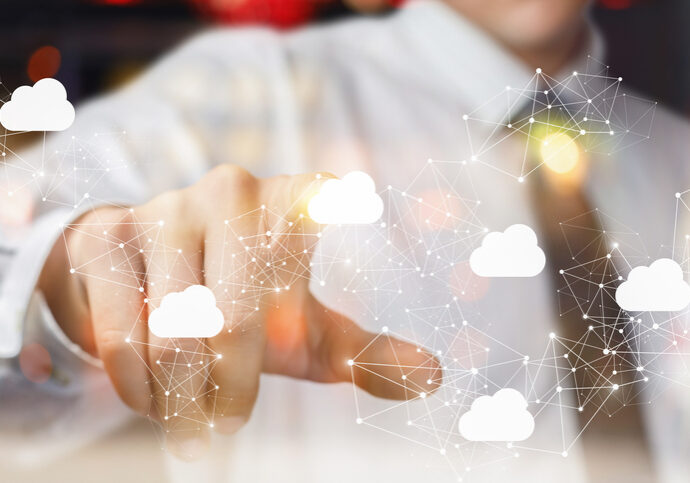 The businessman clicks on the cloud in network on blurred background.